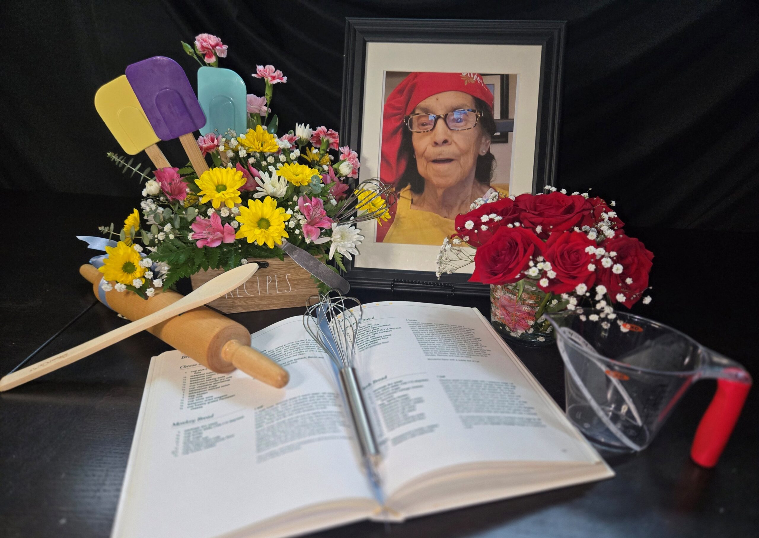 Floral arrangement with cookbook and keepsakes